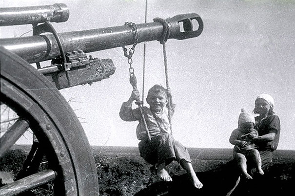 Дети, играющие на брошенной немецкой пушке после битвы под Сталинградом