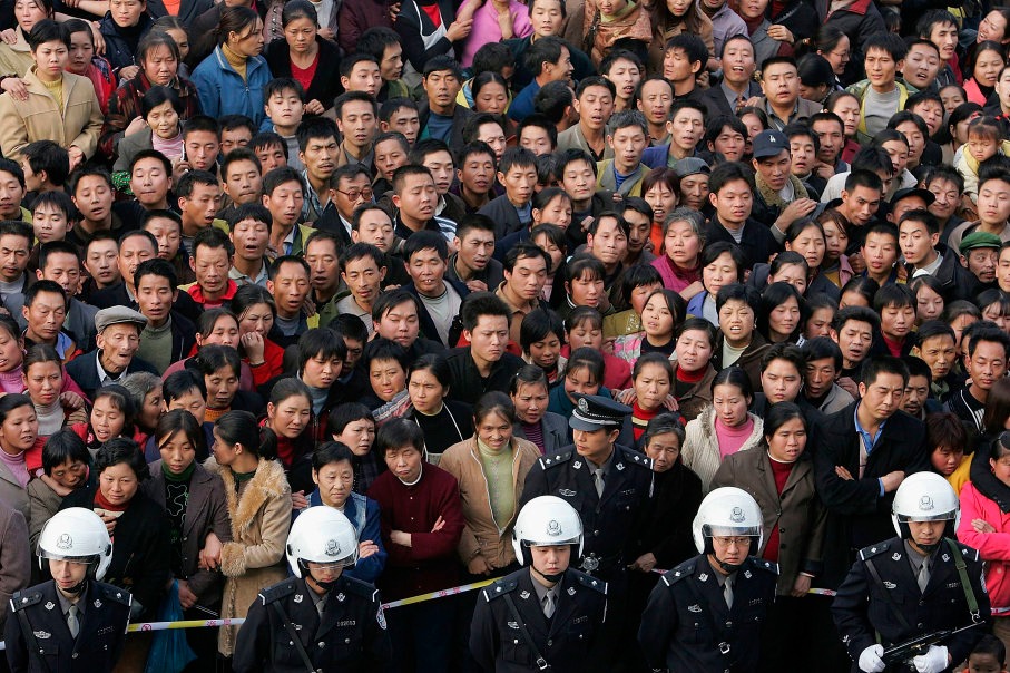 Более 10 000 жителей города Чунцин, Китай, наблюдают за публичным вынесением приговора четырем убийцам в рамках кампании, проводимой местными властями, чтобы продемонстрировать свою решимость подавить вспыхнувшие преступления в 2004 году.